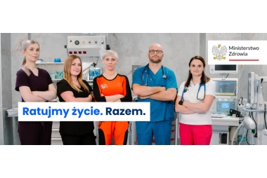 Zdjęcie 5 osób, 4 kobiet i 1 mężczyzny w sali szpitalnej. Ubrani są strój pielęgniarek, lekarzy i ratonika medycznego. 
